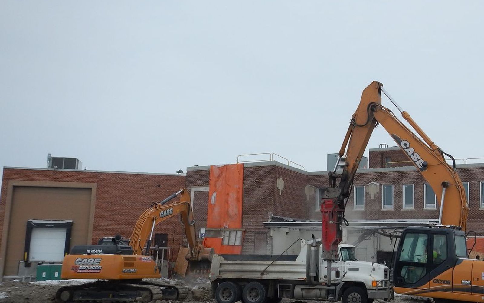 Two DJN excavators and a dump truck on a demolition
