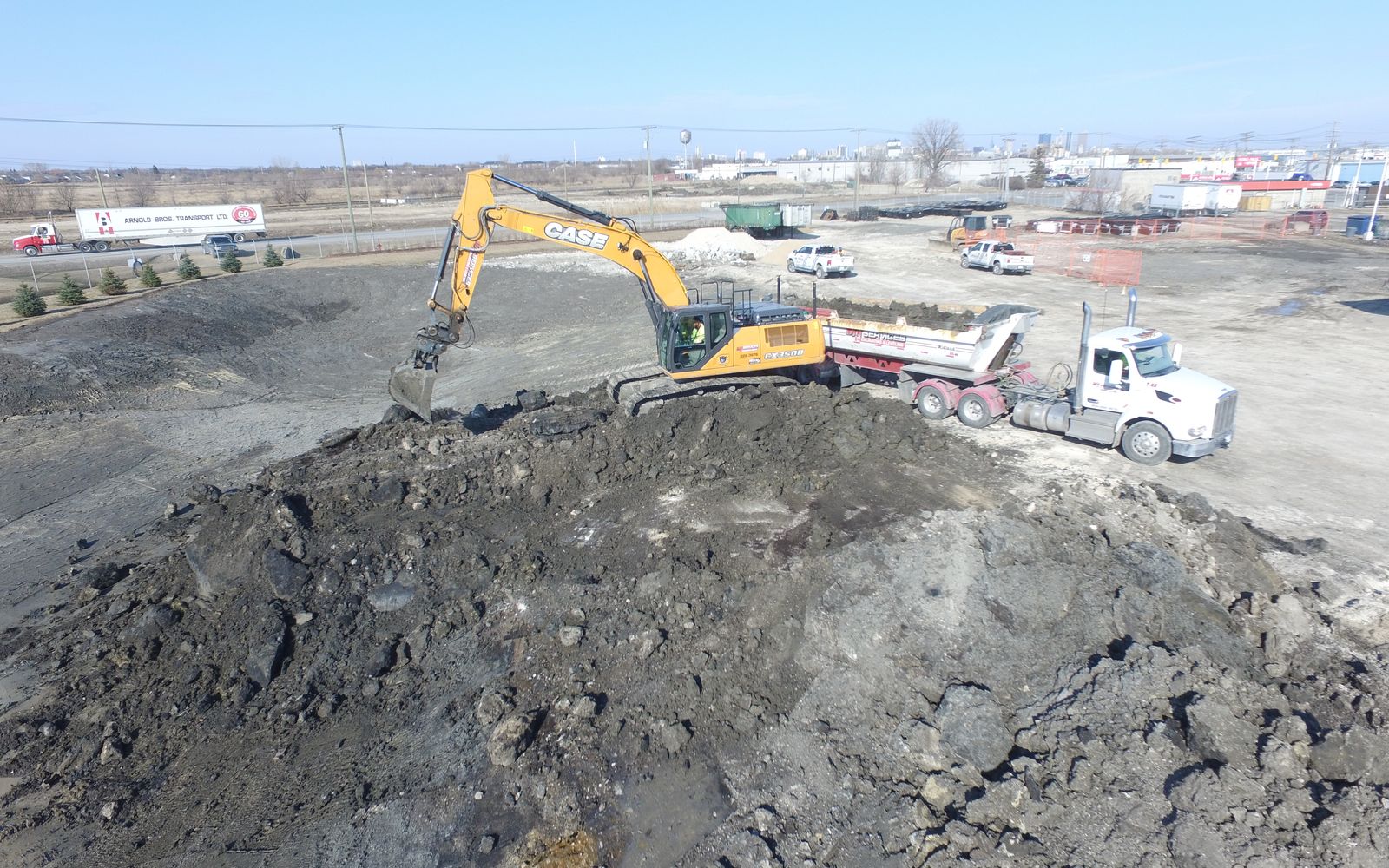 DJN excavator loading an end dump truck